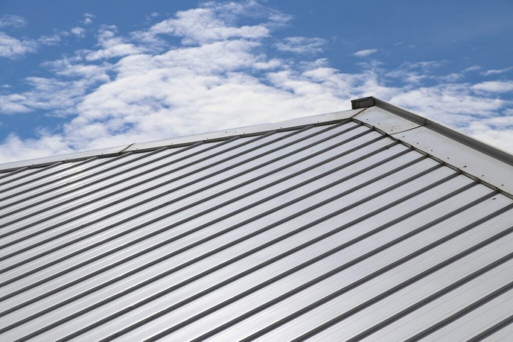 Metal sheet roofing with panels