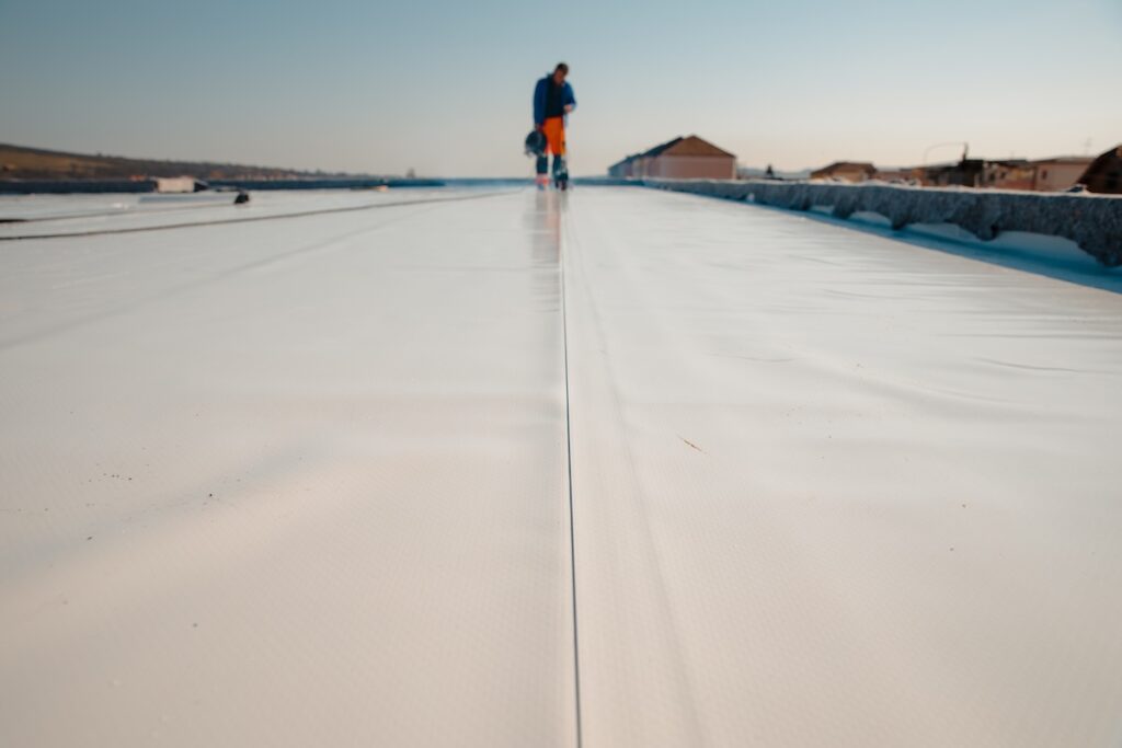 cleaning single-ply roofing material on commercial building