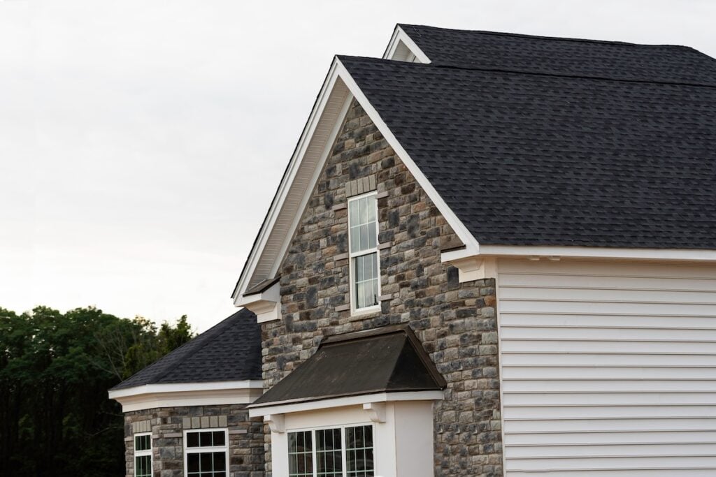 edge of roof shingles on top of the house dark asphalt tiles on the roof