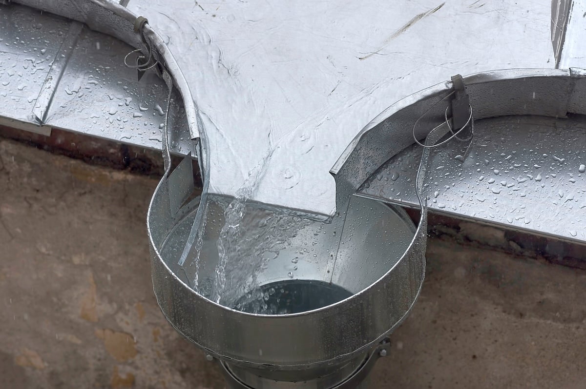 Rain water flows down the roof into the drain