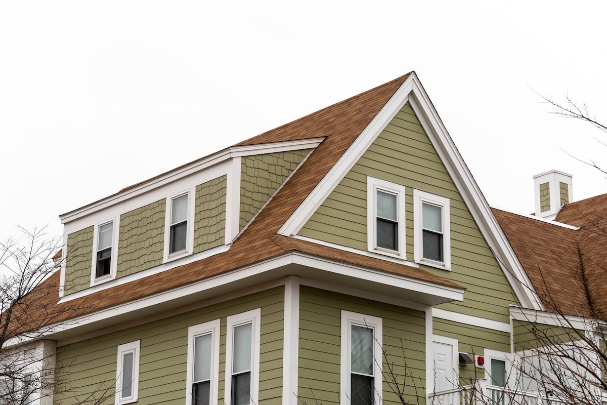 Exterior view of a newly built family house with shed dormer windows