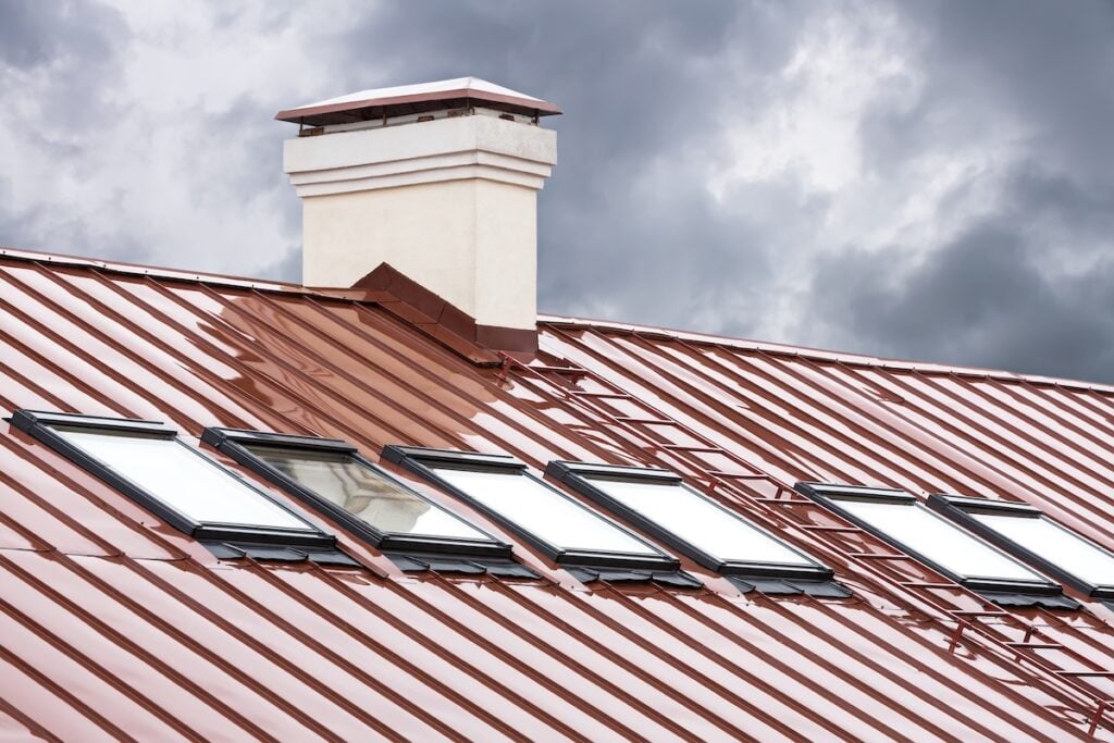new copper metal roof with skylights and chimney