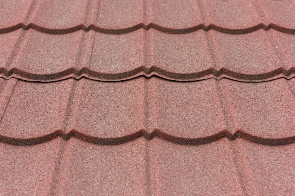 Texture of stone coated steel roof tiles in red color