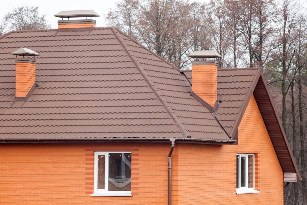 New brick house with modular chimney, Stone Coated Metal Roof Tile, plastic windows and rain gutter