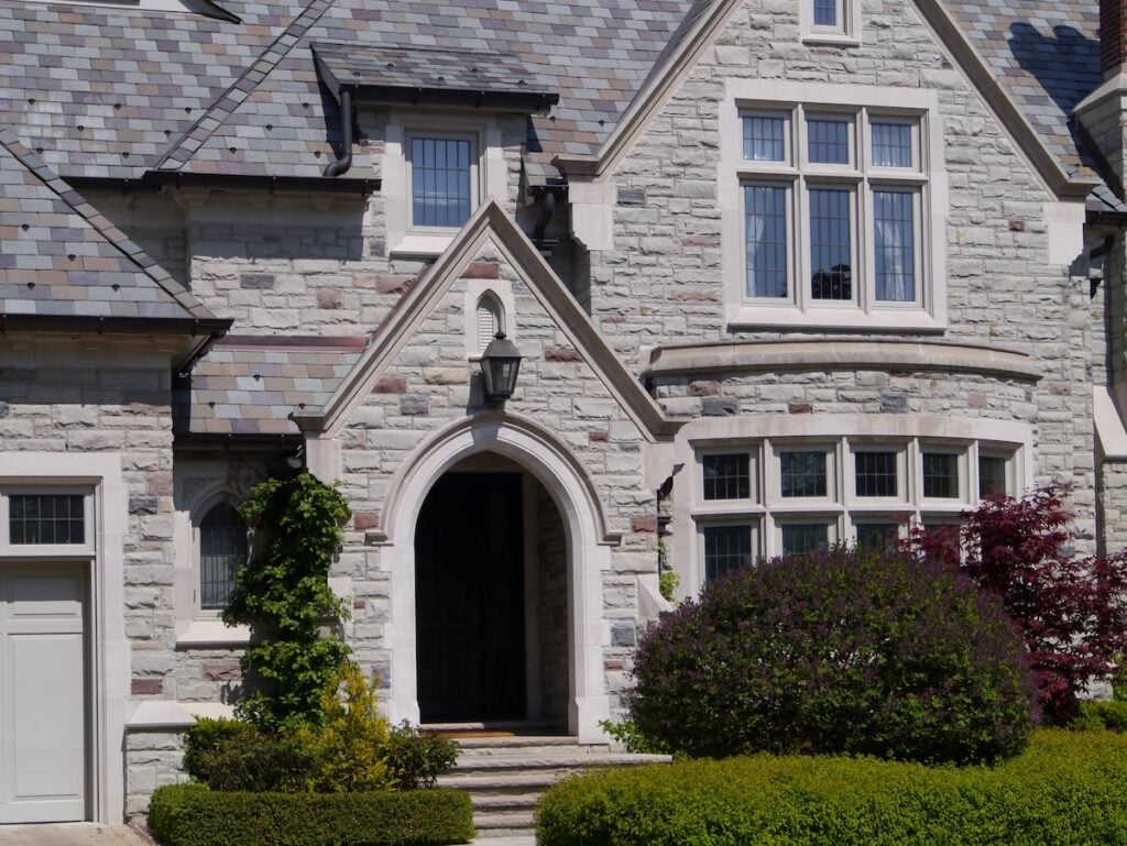 large stone house with synthetic slate roof
