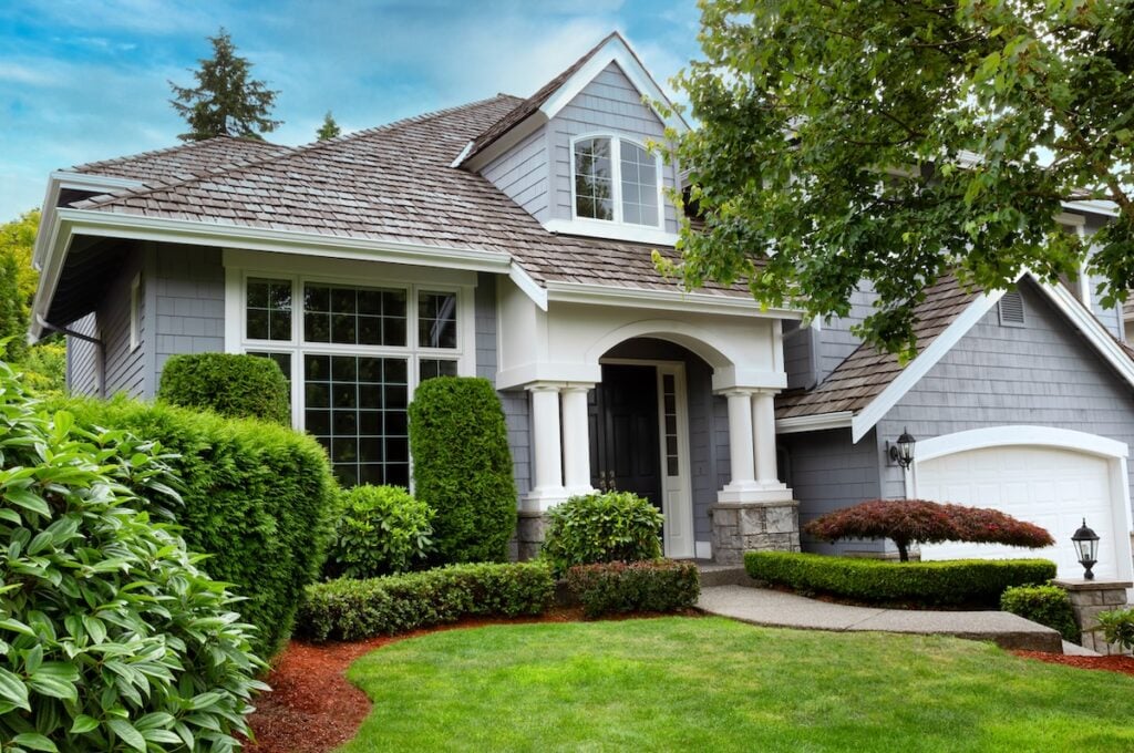 Close up view of a modern home with cedar shake roof