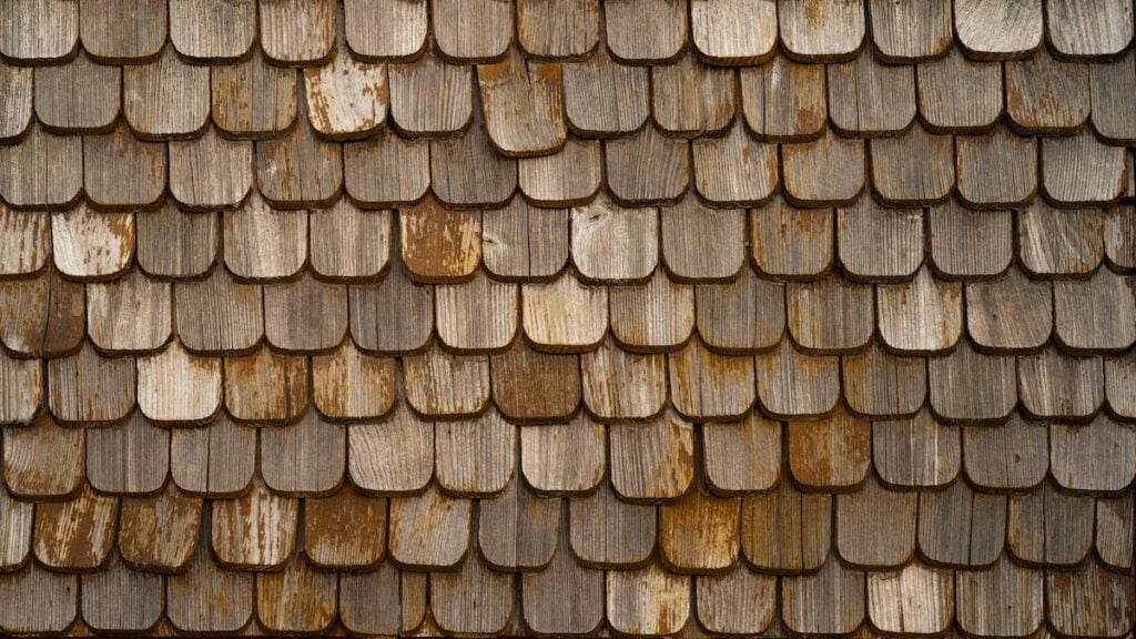 Old brown rustic wooden shingle wall texture
