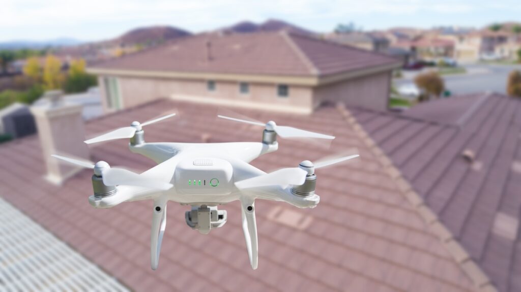 drone roof inspection with drone flying above roof