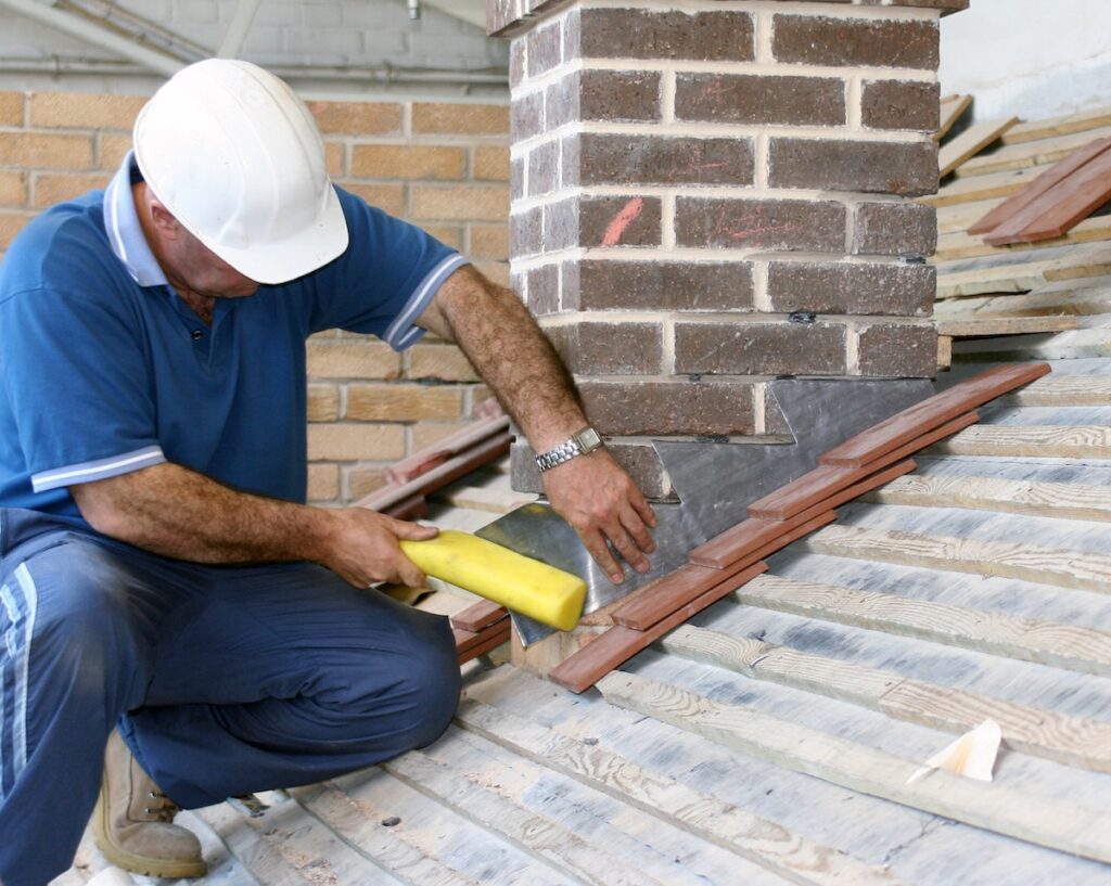 Close-up of trainee roofer on building site
