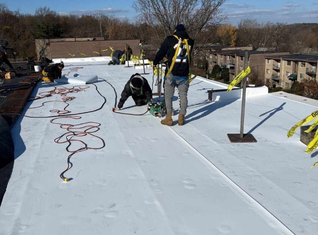 roofers installing and fixing flat commercial roof
