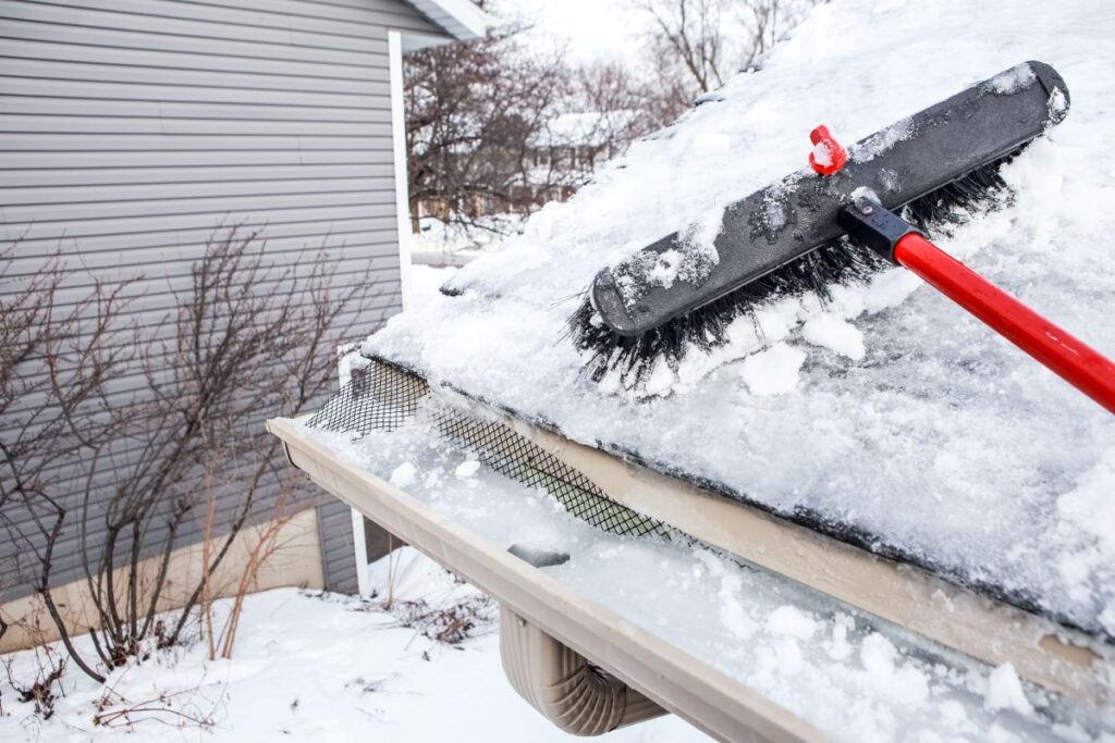 snow and ice being removed from roof