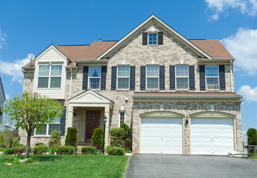 Single family house, with two car garage. and mixed material siding