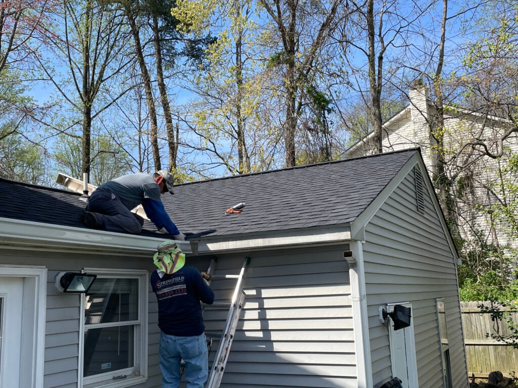 how to install drip edge Springfield Roofing worker repairing roof