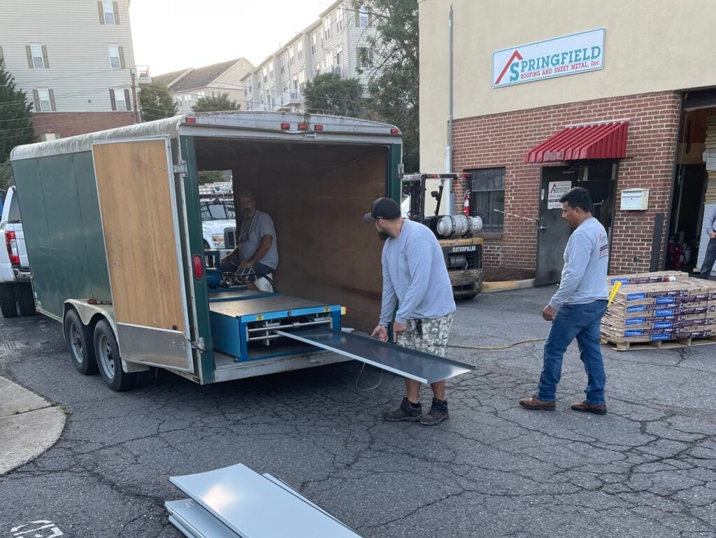 commercial roof maintenance checklist Springfield worker holding panels