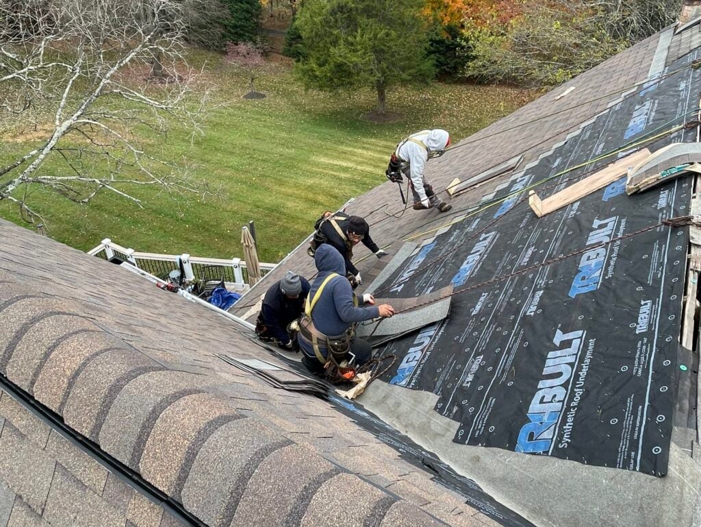 asphalt roof repair Springfield Roofing workers replacing shingles roof
