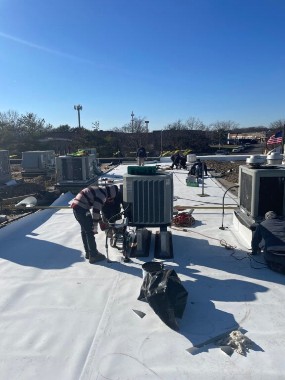 commercial roofing maintenance Springfield Roofing worker checking on HVAC