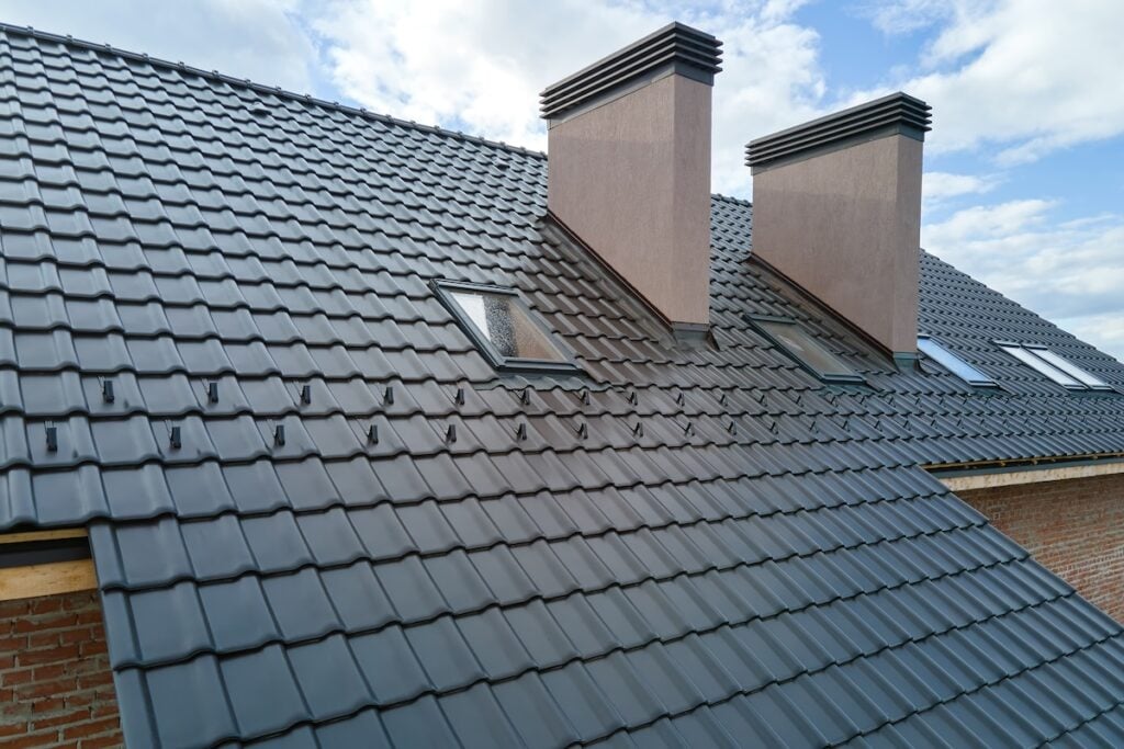 Slate roof with two brick chimneys and skylight windows