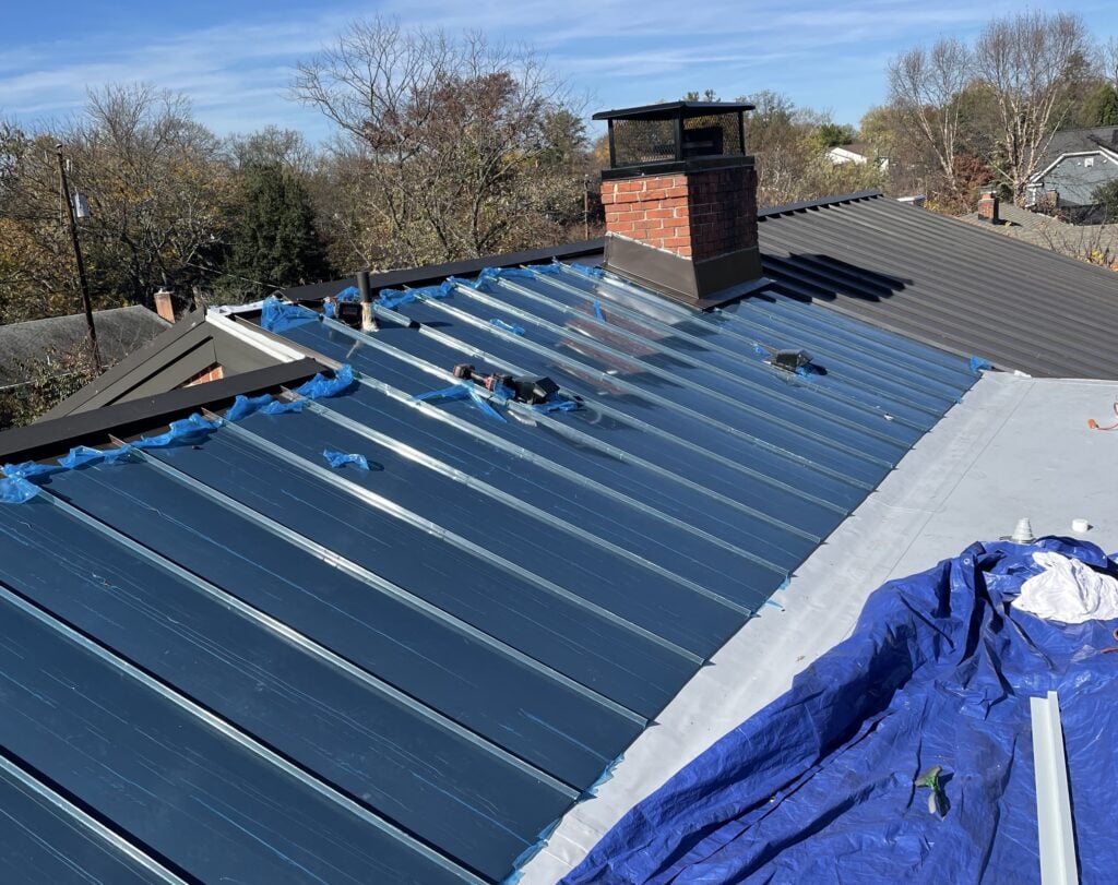 A standing metal roof being installed