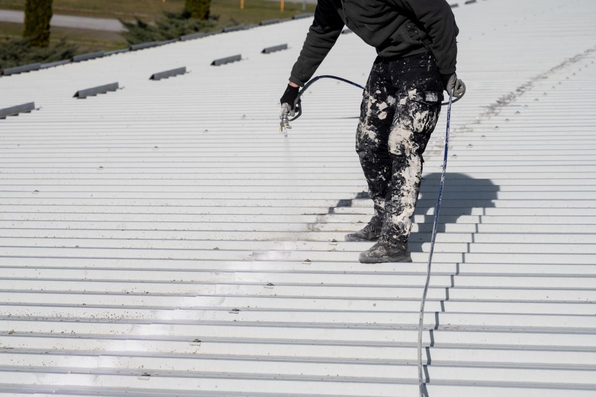 Metal roof painting with compressor