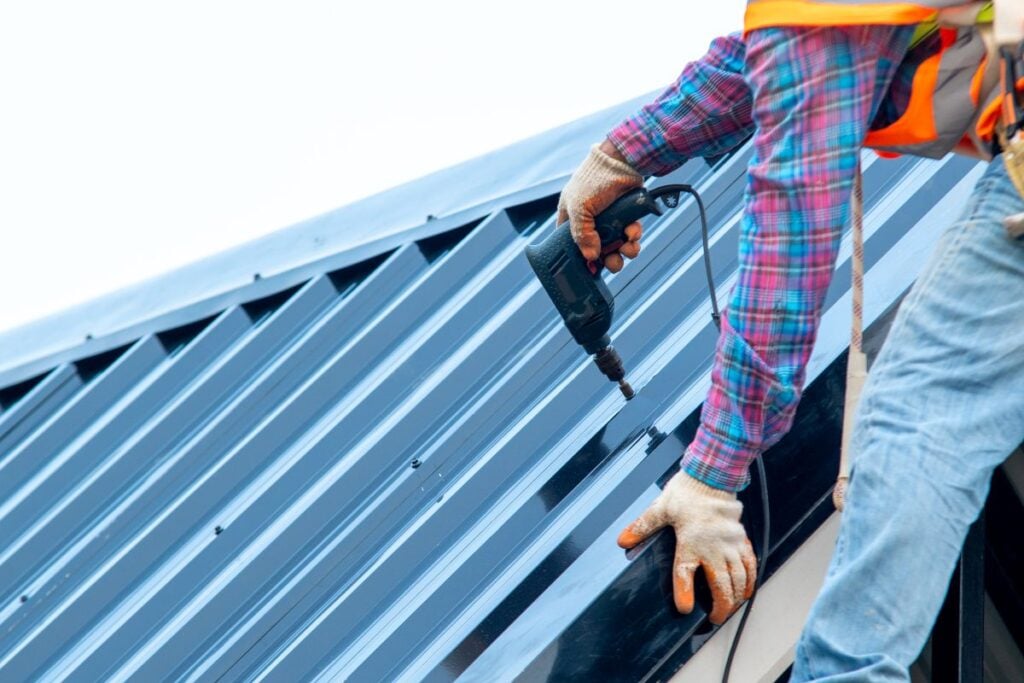 roofer fixing metal roof