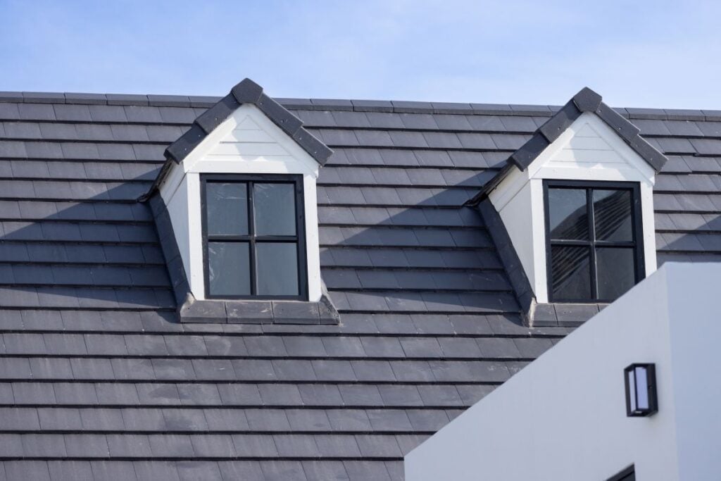 white house with black slate tile roof
