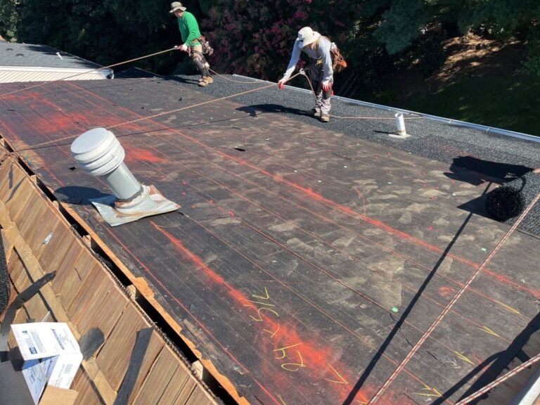 What Does a Roof Warranty Cover? (And What It Doesn't) Springfield Roofing team working on a roof