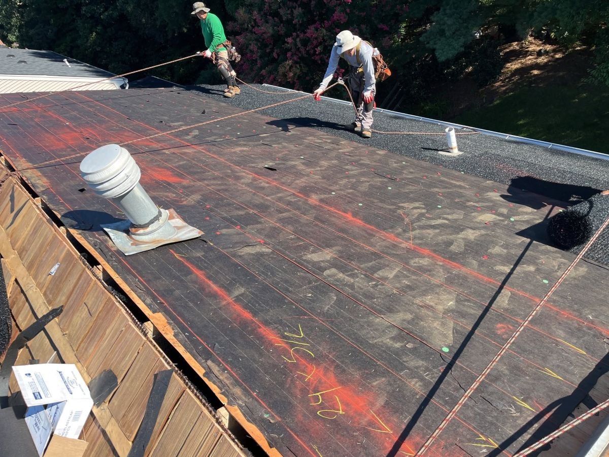 What Does a Roof Warranty Cover? (And What It Doesn't) Springfield Roofing team working on a roof