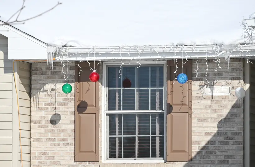 Colorful christmas lights hanging on gutters