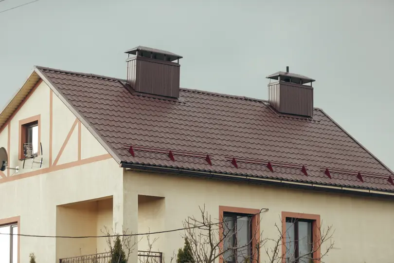 Private residential building with metal roofing and snow guards. Metal Roof Snow Guards